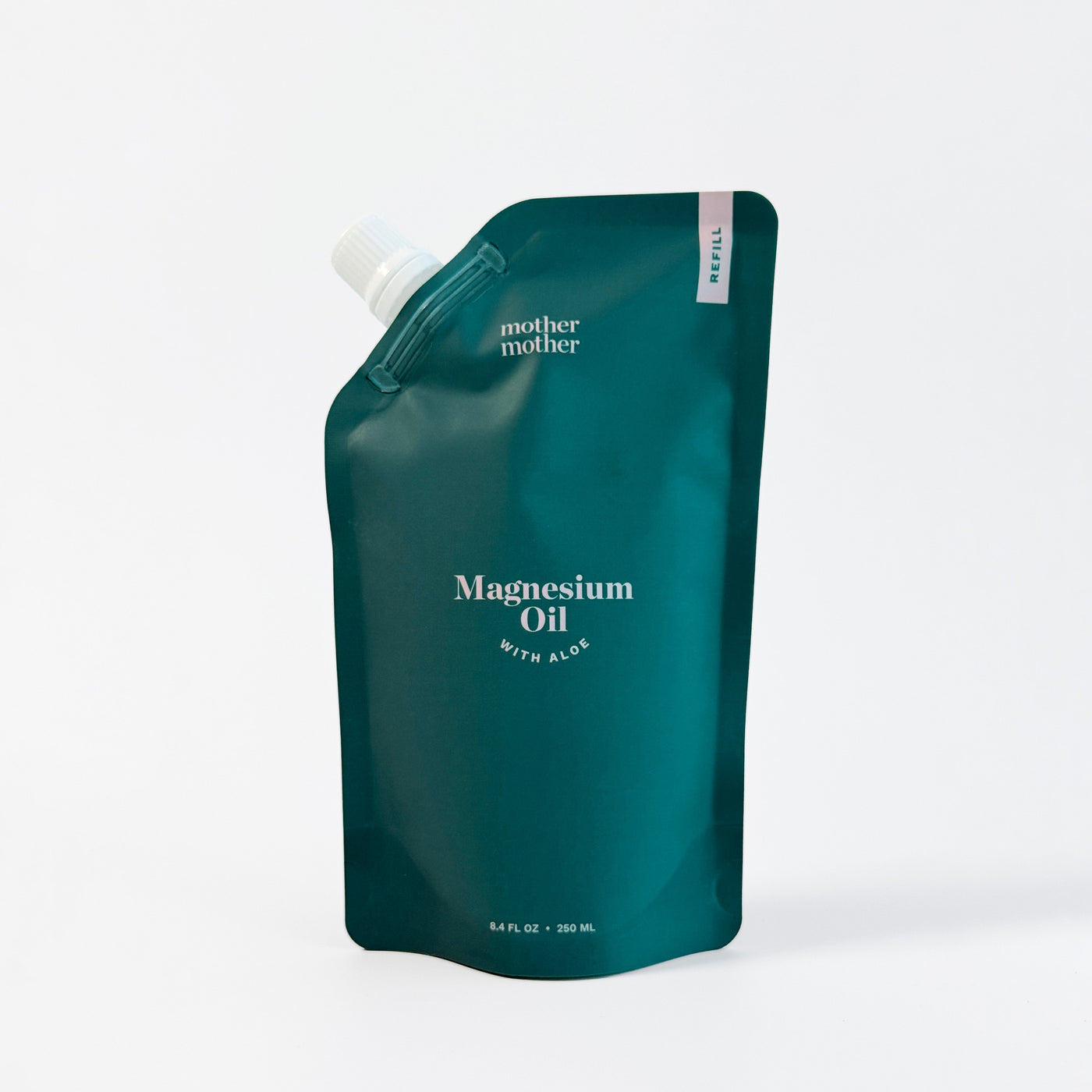 Green pouch of magnesium oil with a white pump on a white background